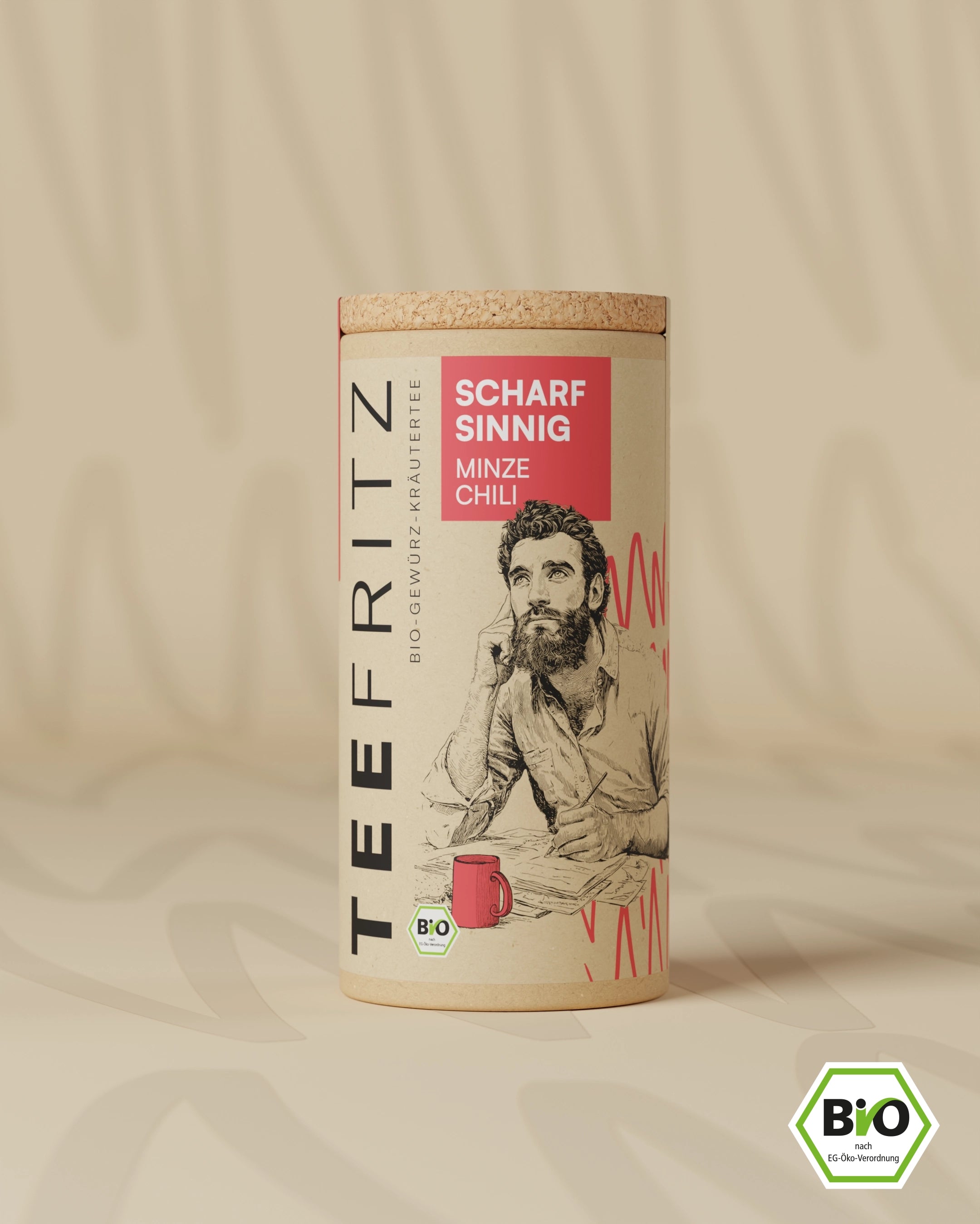 Teedose in runder Pappverpackung mit der Aufschrift „Scharfsinnig Minze Chili“ und einem gezeichneten Mann.