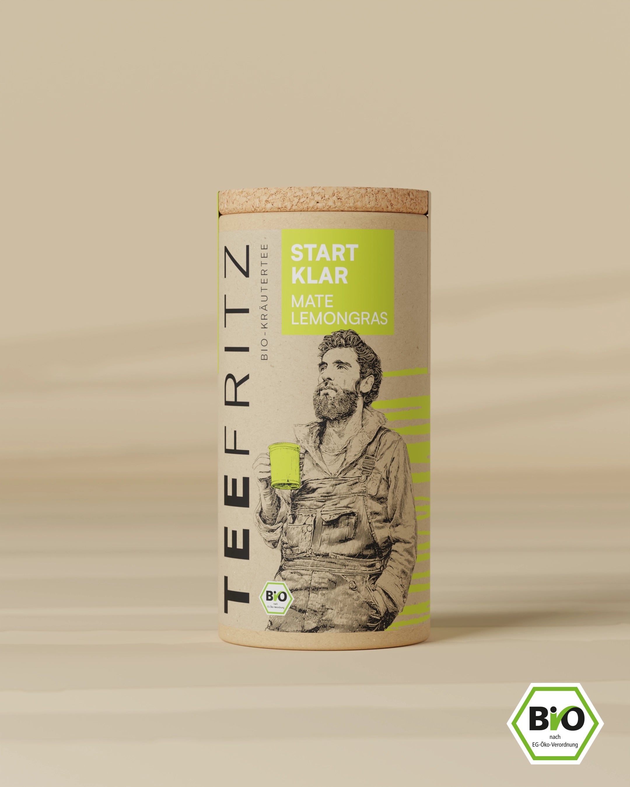 Verpackung von Bio-Kräutertee "START KLAR Mate Lemongras" mit Illustration eines Mannes, der eine Tasse hält.